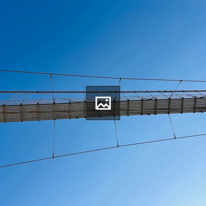 Suspension bridge against blue sky