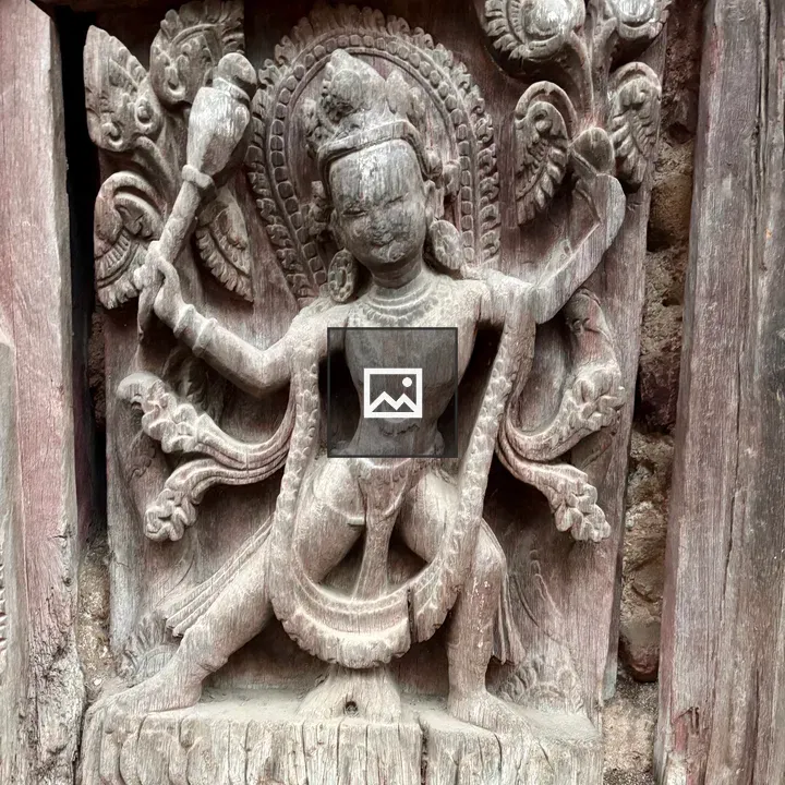 Intricate wood carving of a deity