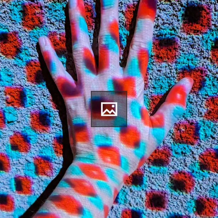 Hand Against Wall with Light Dots