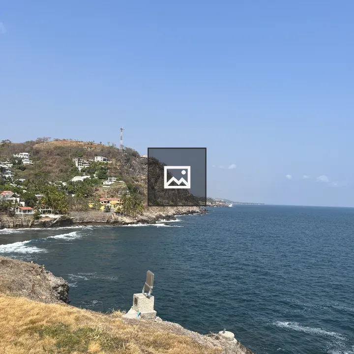 Rocky coastline with hillside homes