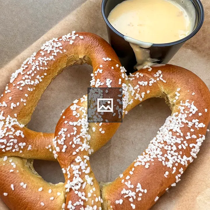 Salted pretzel with cheese sauce