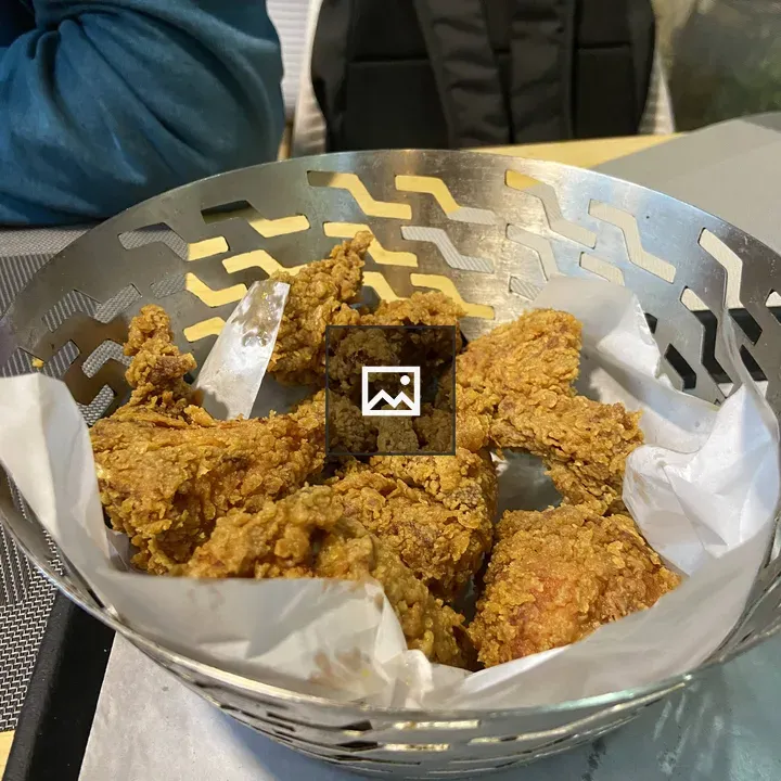 Crispy fried chicken pieces in basket