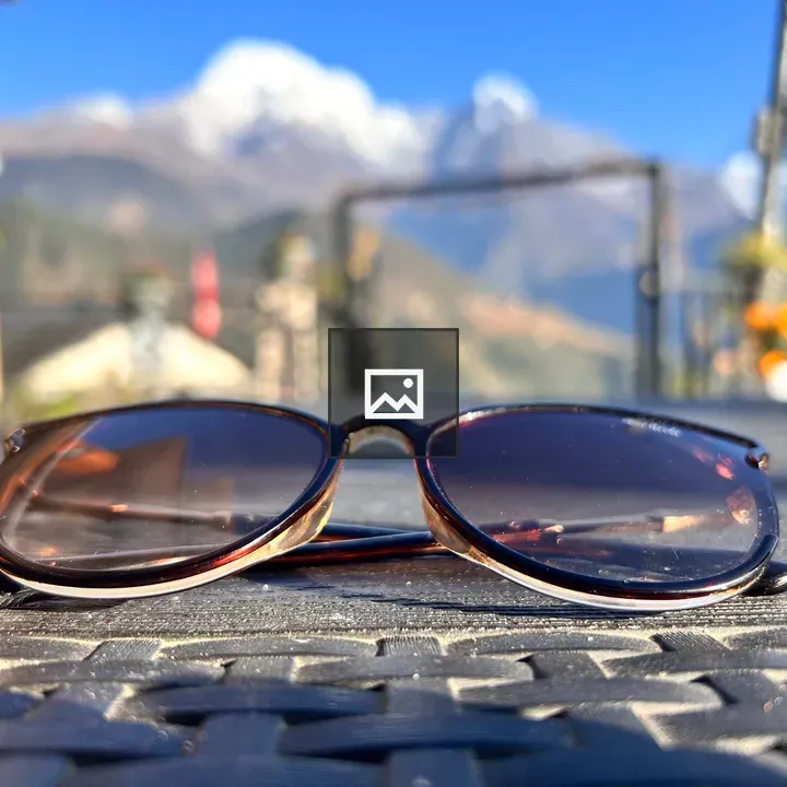 Black sunglasses on snowy backdrop