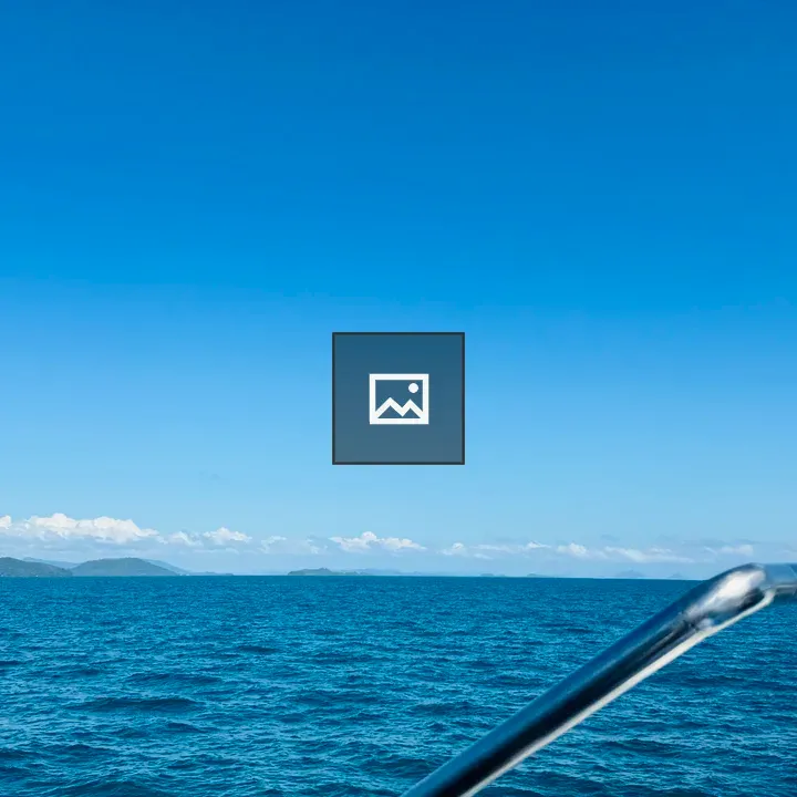 Boat on blue ocean with islands
