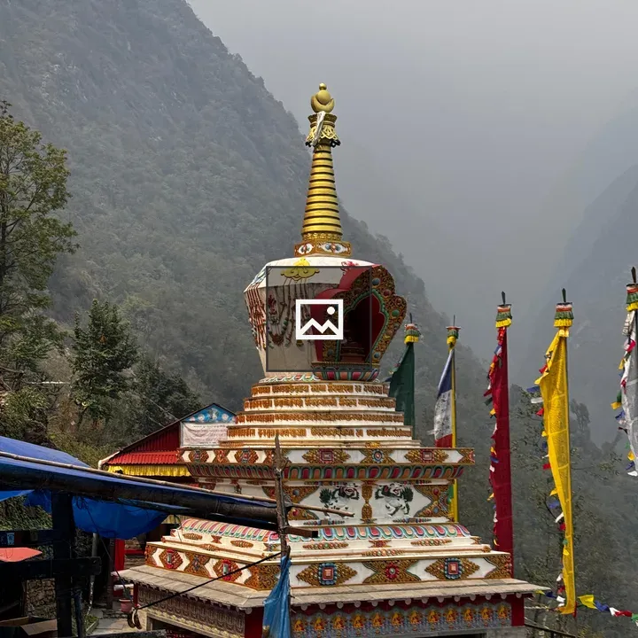 Stupa with Golden Spire in Mountain Landscape