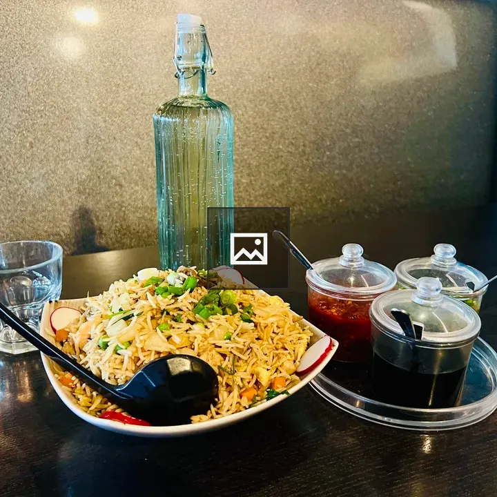 Plate of fried rice with green onions