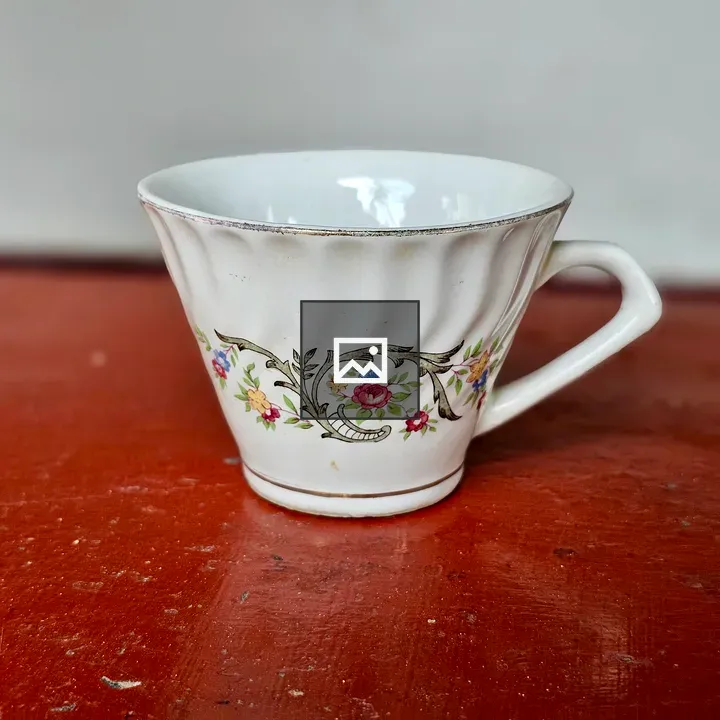 White teacup with floral patterns