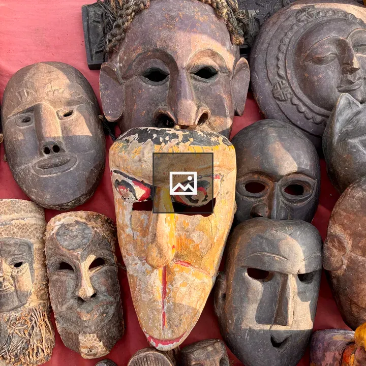 Traditional Masks Displayed on Red Fabric