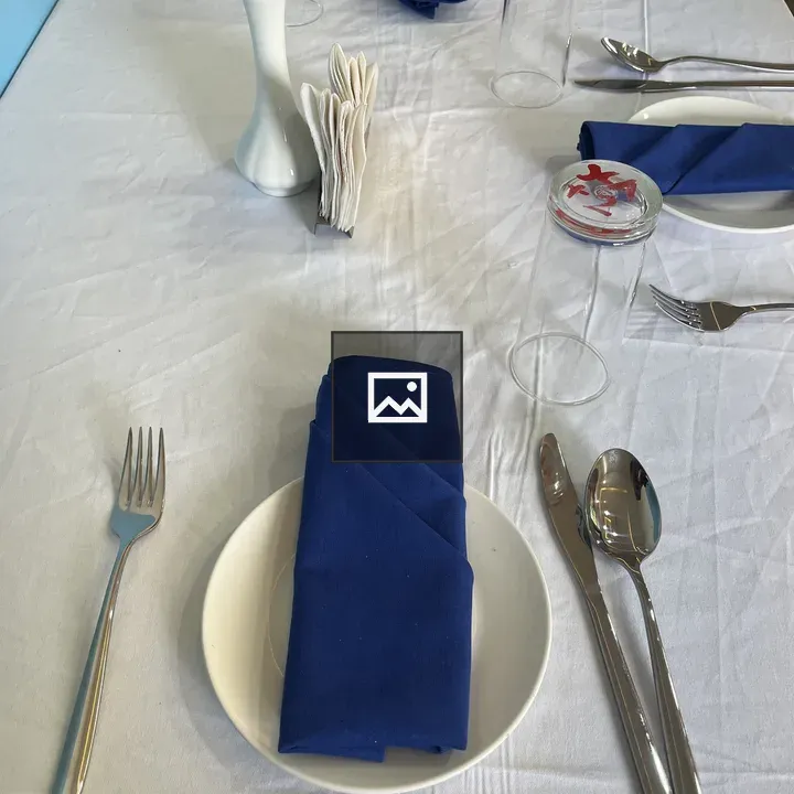 Formal table setting with blue napkins