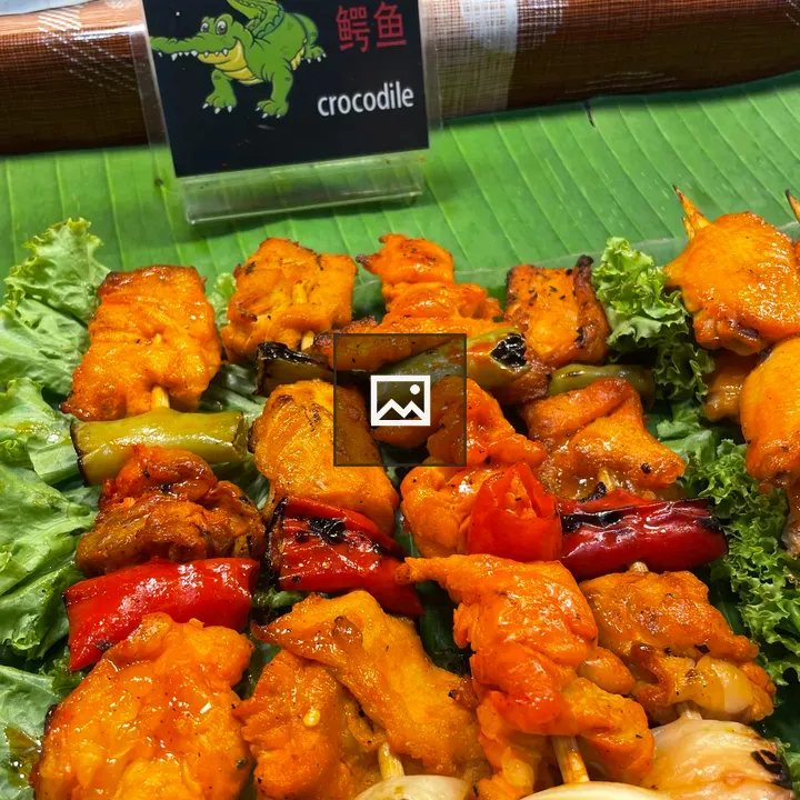 Skewers of crocodile meat