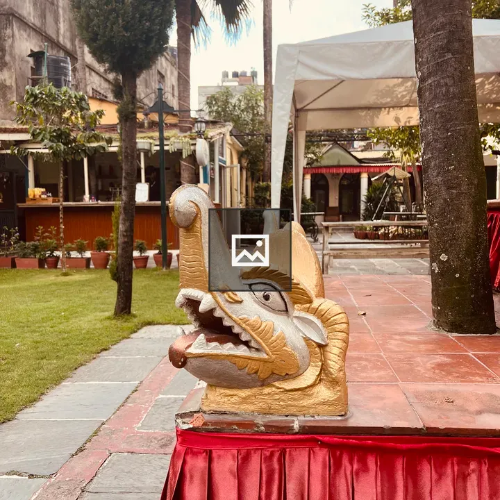 Elephant-head sculpture on red cloth