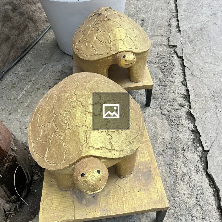 Two turtle sculptures on boards