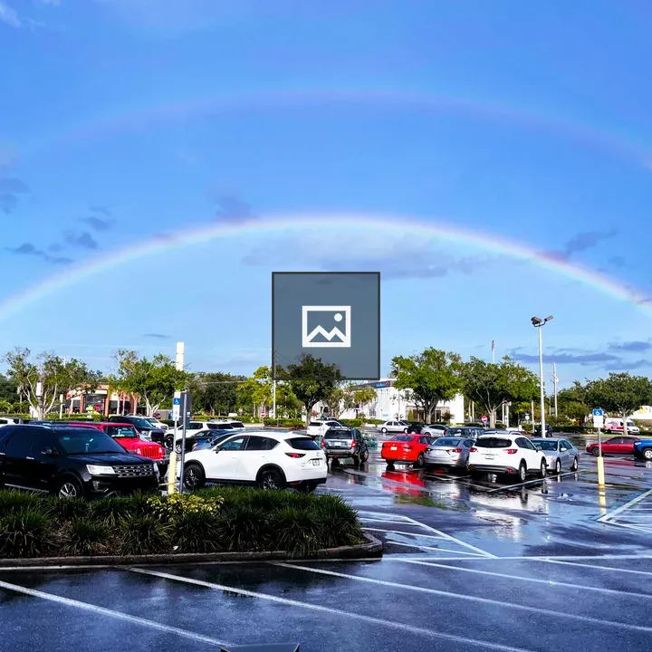 Double rainbow over parking lot