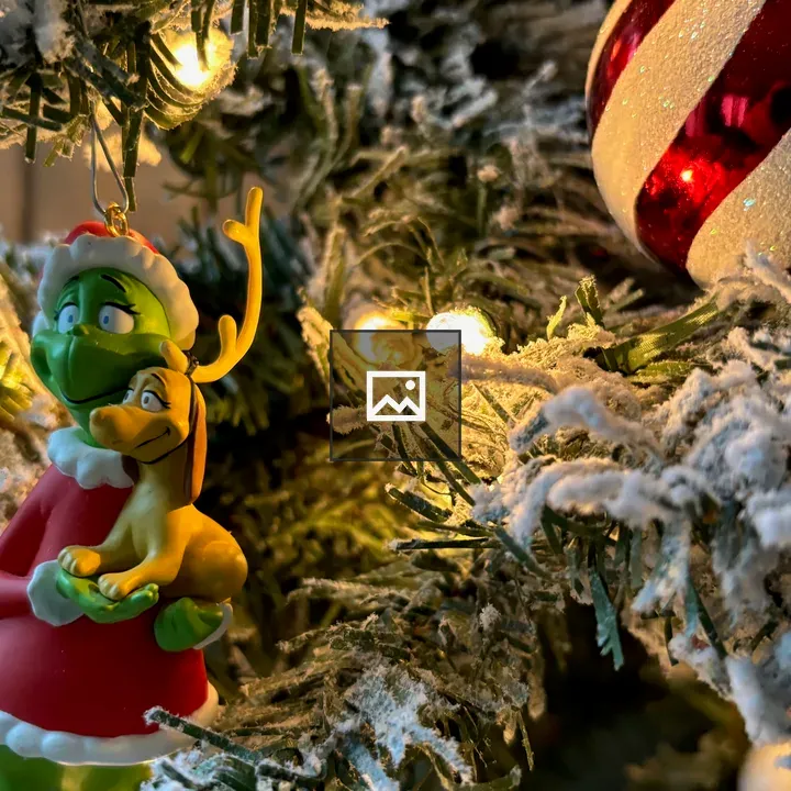 Grinch ornament in tree branches