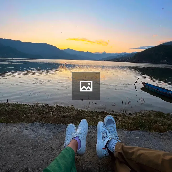 Two pairs of legs in sneakers by Fewa Lake