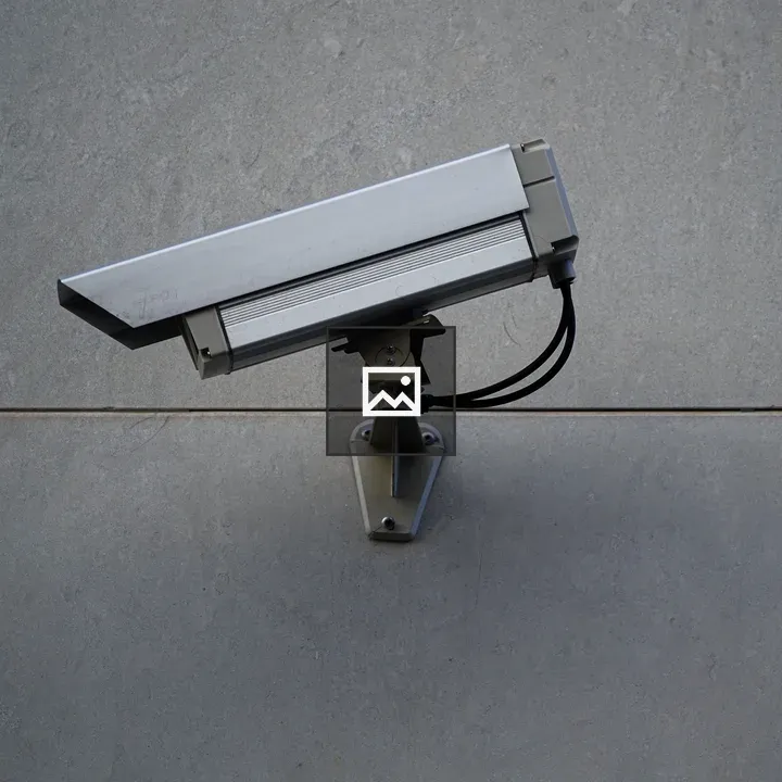 CCTV camera on gray wall