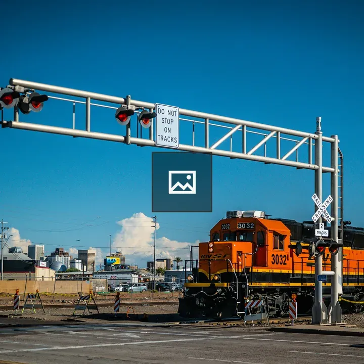 Orange Train Crossing Street