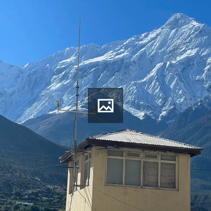 Antenna on small building with mountains