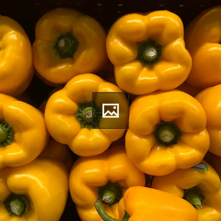 Yellow peppers packed stem side view