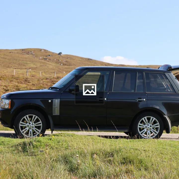 Man beside black Range Rover Vogue