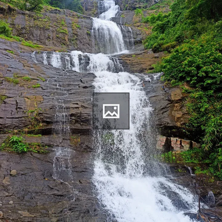 Mountain waterfall with vegetation