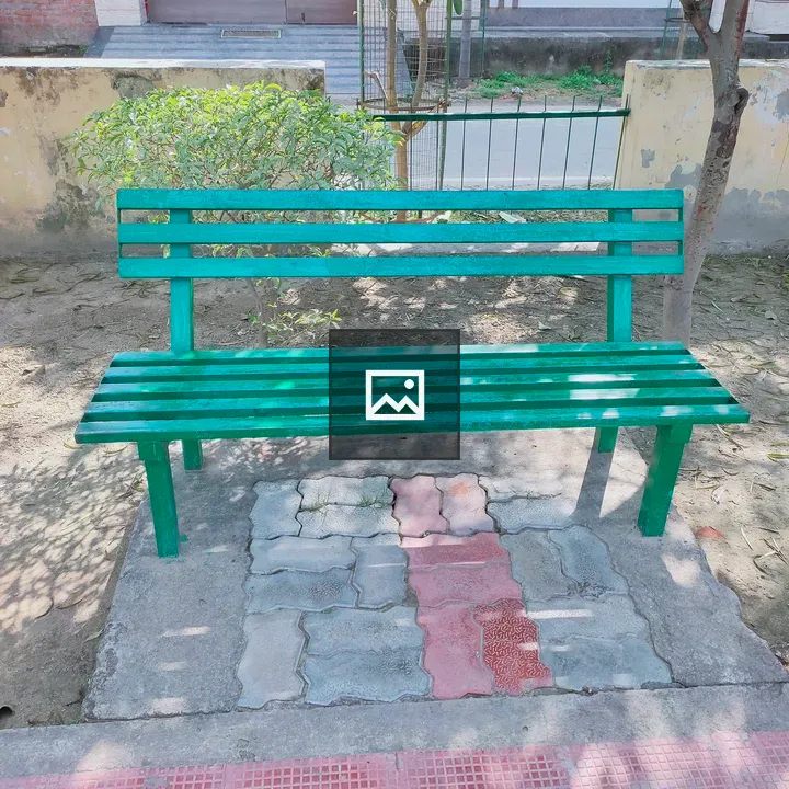 Green wooden bench in park